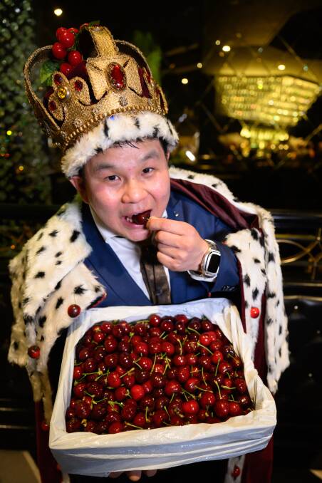 The newly crowned 2022 cherry king, Robert Lo, Pro Bros Providore, tucks into one of his cherries. Picture supplied
